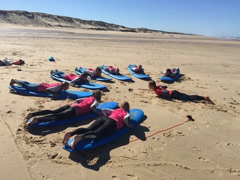 Ben coaching a group of beginners on the sand